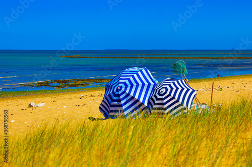 striped blue white umbrella on the beach