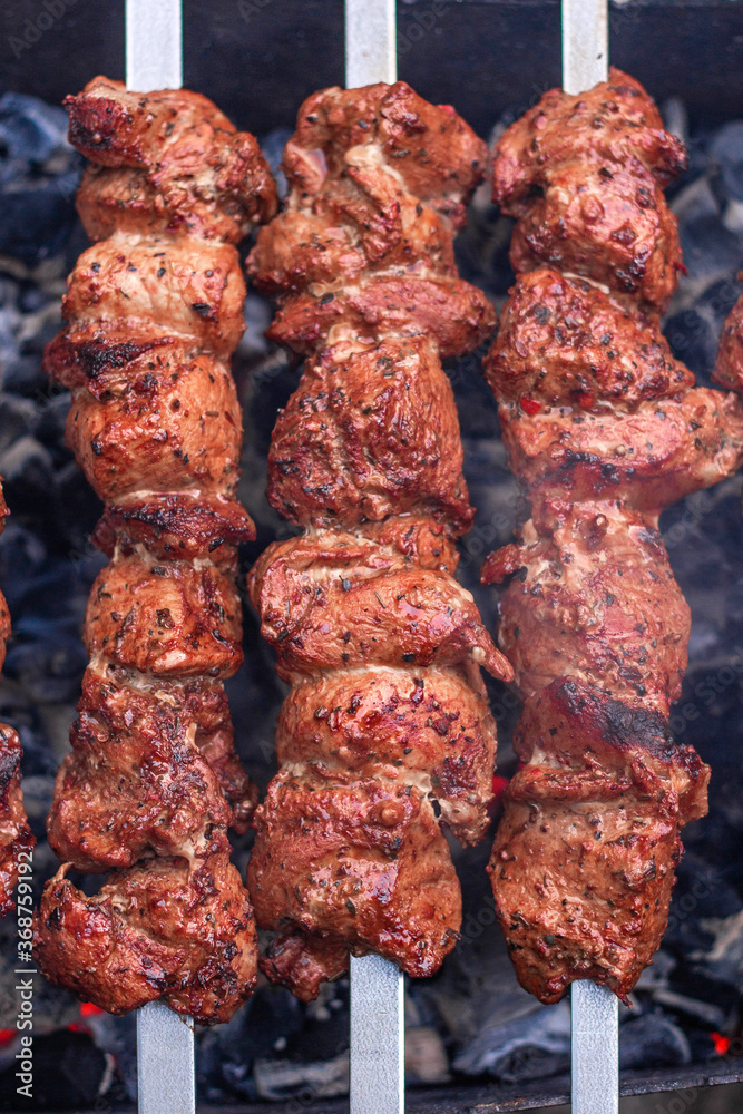 Meat on skewers is cooked on hot coals