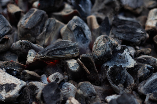 Black hot coal, close-up. Black charcoal background © PAVEL GERASIMENKO