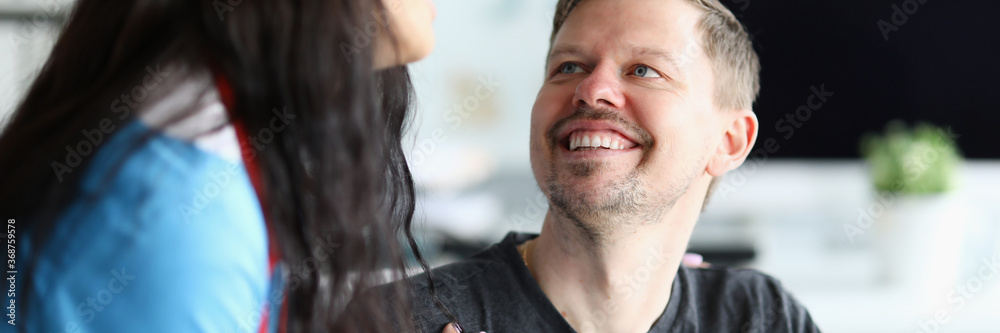 Obraz premium Smiling man looks at doctor woman with confidence. Restoration ability people with disabilities to household, social activities. Rehabilitation in clinic. Restore and adapt to life after an accident