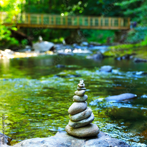 stone zen, river and suspended wooden brige background