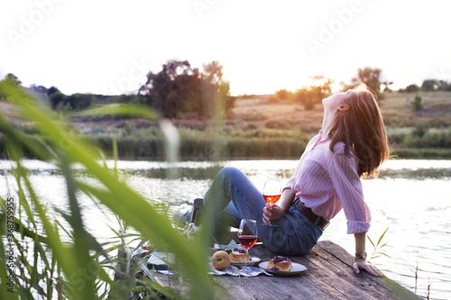 girl enjoying picnic on a wooden pie