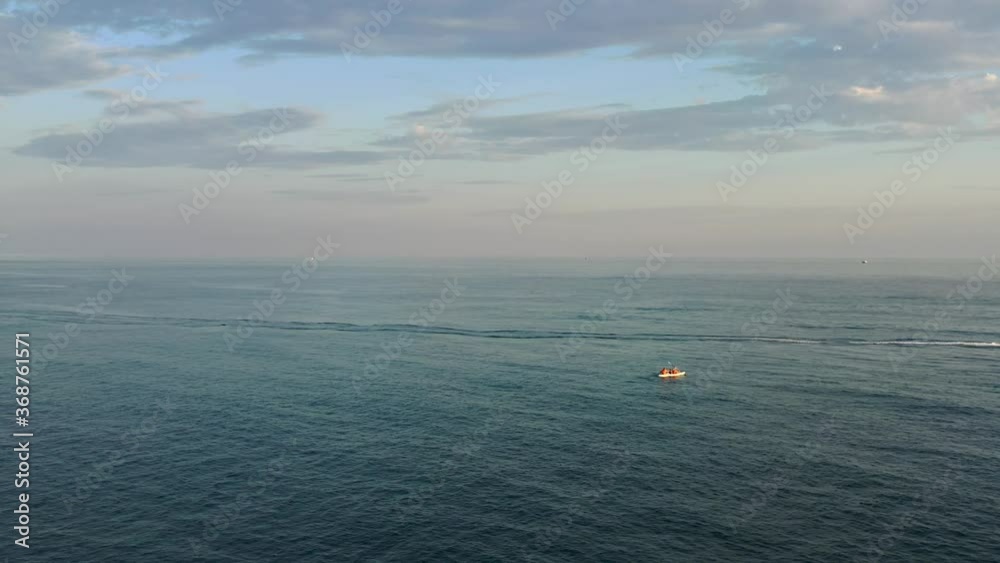 Aerial view of drone flight above calm and tranquil turquoise ocean water, smooth shimmering surface as backdrop or wallpaper. Sunset Aerial view of drone flight above calm and tranquil turquoise ocean water, smooth shimmering surface as backdrop or wallpaper. Sunset