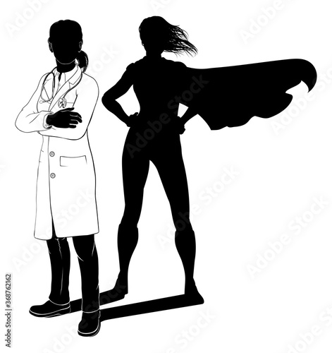 A doctor woman in silhouette revealed as a super hero by her shadow.