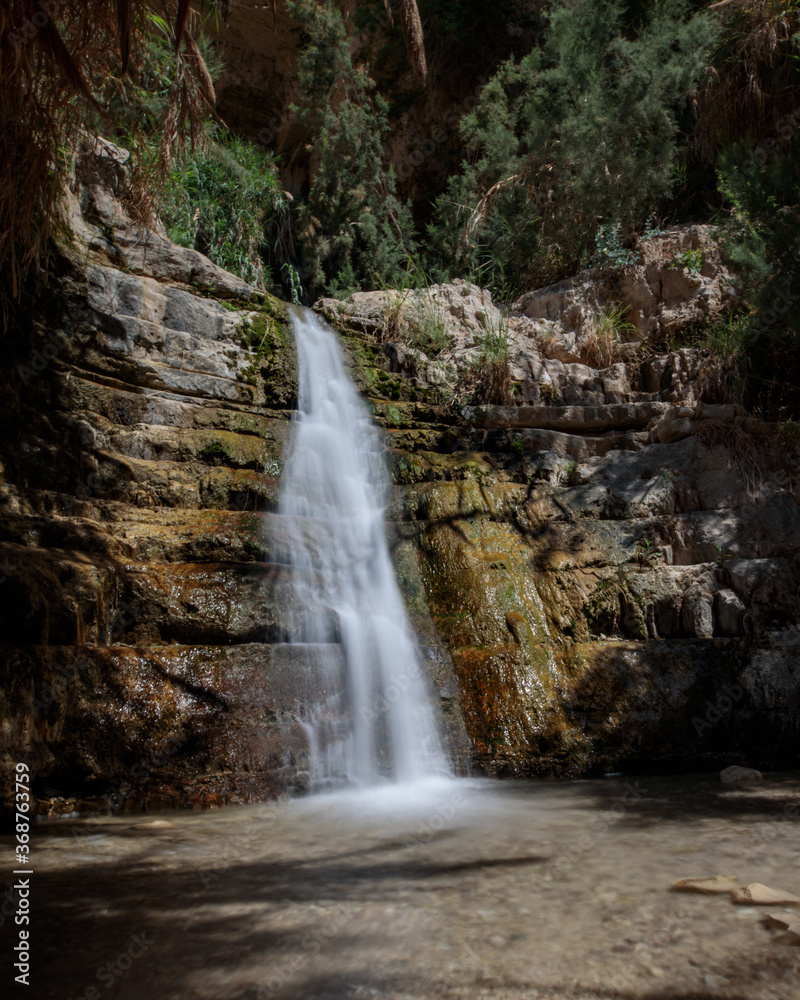 Waterfall in the desert – part of the Ein Gedi oasis natural reserve in southern Israel. Long exposure shot.