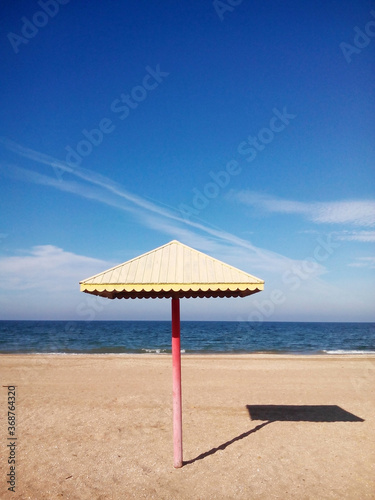 Beach umbrella on the sandy seashore