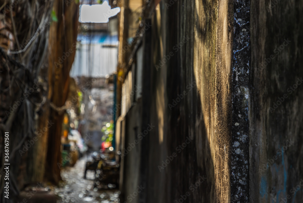 The light that shines down at the wall of narrow street in the old village. Focus and blur. The light that shines down at the wall of narrow street in the old village. Focus and blur.