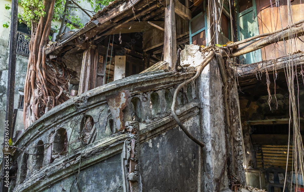 Bangkok,Thailand - Jan 25, 2020 : The remains of a derelict abandoned ancient house with antique stone stairs and tree roots. Archaeological area. No focus, specifically.