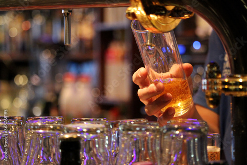 Bartender serving a beer rod from a tap