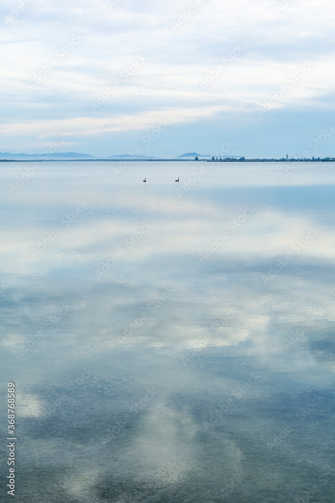 Cloudy sky reflected in the water