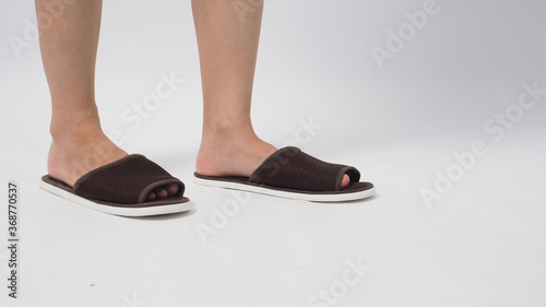 Asian female foot and wear slipper isolated on white background.