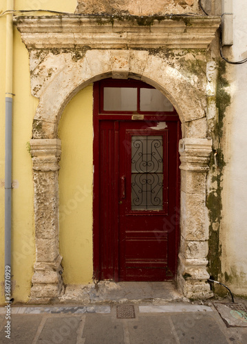 Medieval gate and modern time door in modern Rethymno, Crete island, Greece.  © YiannisMantas