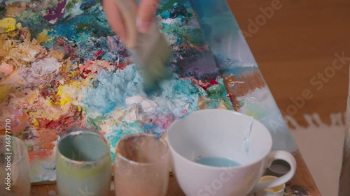 Female painter working on painting in her studio photo