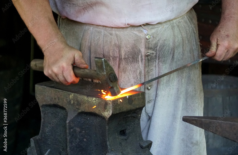 A molten metal being shaped on top of an anvil A molten metal being shaped on top of an anvil