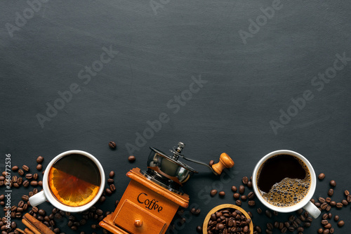 hot coffee, bean and hand grinder on black table background. space for text. top view