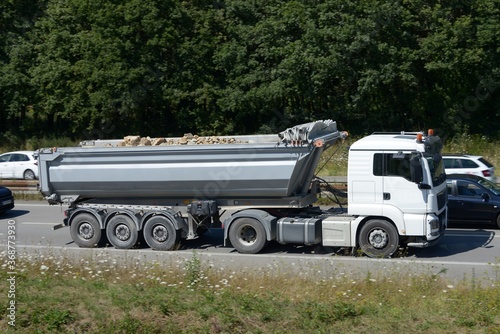Camion benne avec des gravats roulant sur une voie express en Bretagne.