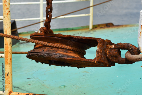 Rusty pulley on board a fishing ship.