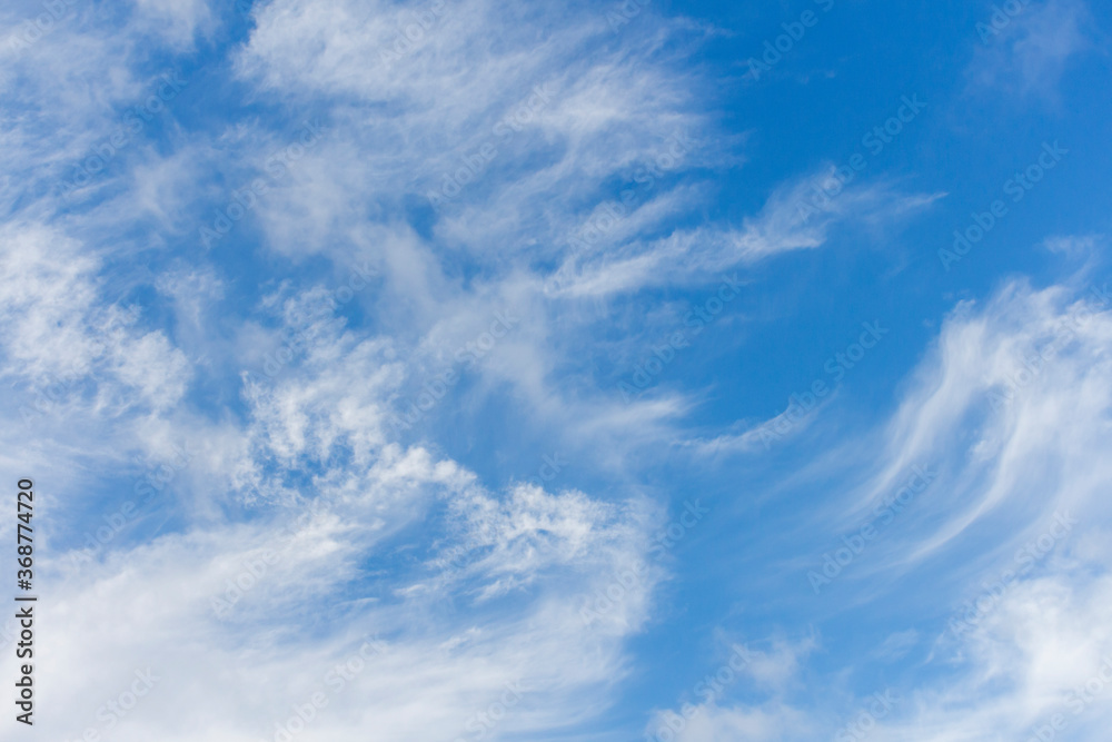 Beautiful Cirrus clouds on the blue sky during summer sunny day. Theme of beautiful landscapes. 