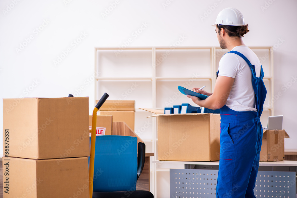 Young male professional mover doing home relocation Young male professional mover doing home relocation