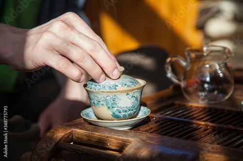 Hand holding a cup of chinese tea
