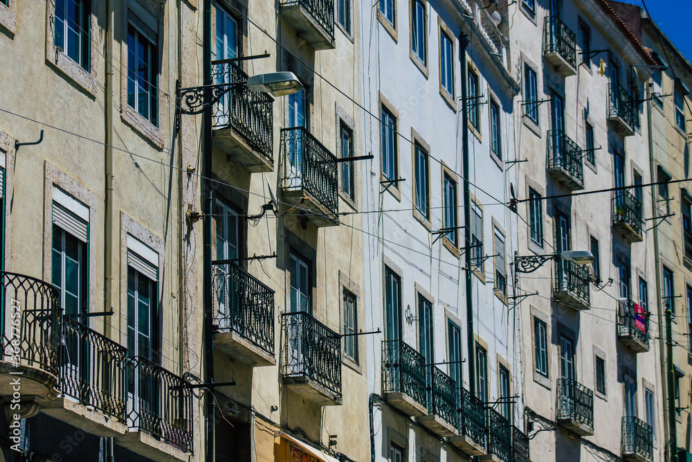 Obraz premium View of classic facade of ancient historical buildings in the downtown area of Lisbon, the hilly coastal capital city of Portugal and one of the oldest cities in Europe 