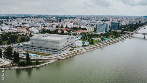 Aerial shot of Duna Arena beside Danube river with driving boat in Budapest,Hungary