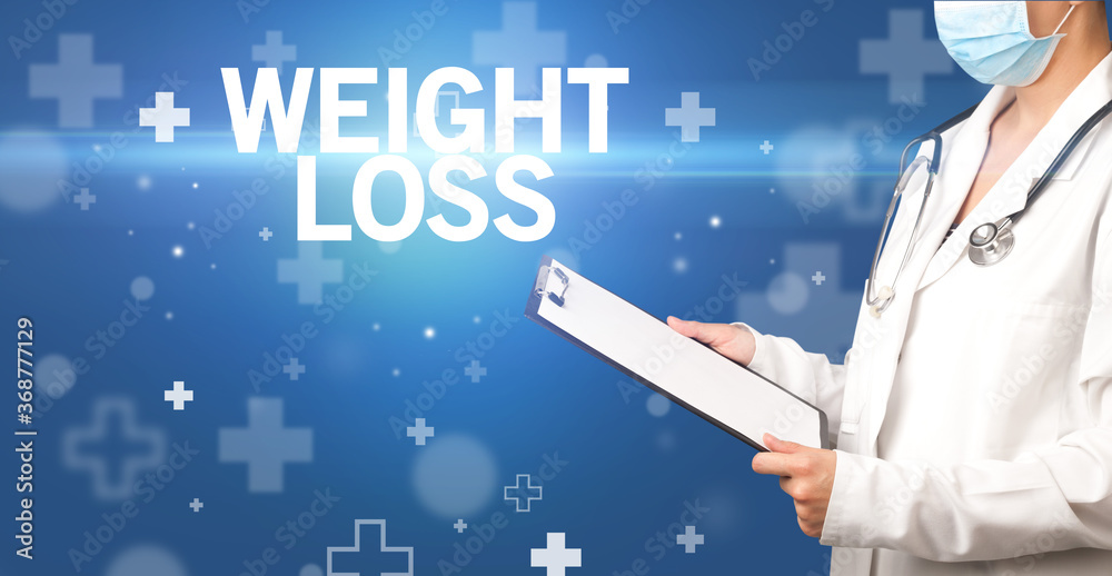 doctor writes notes on the clipboard with WEIGHT LOSS inscription, first aid concept doctor writes notes on the clipboard with WEIGHT LOSS inscription, first aid concept