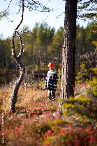 Into the wild. A young girl in the deep and wild forest of Norway