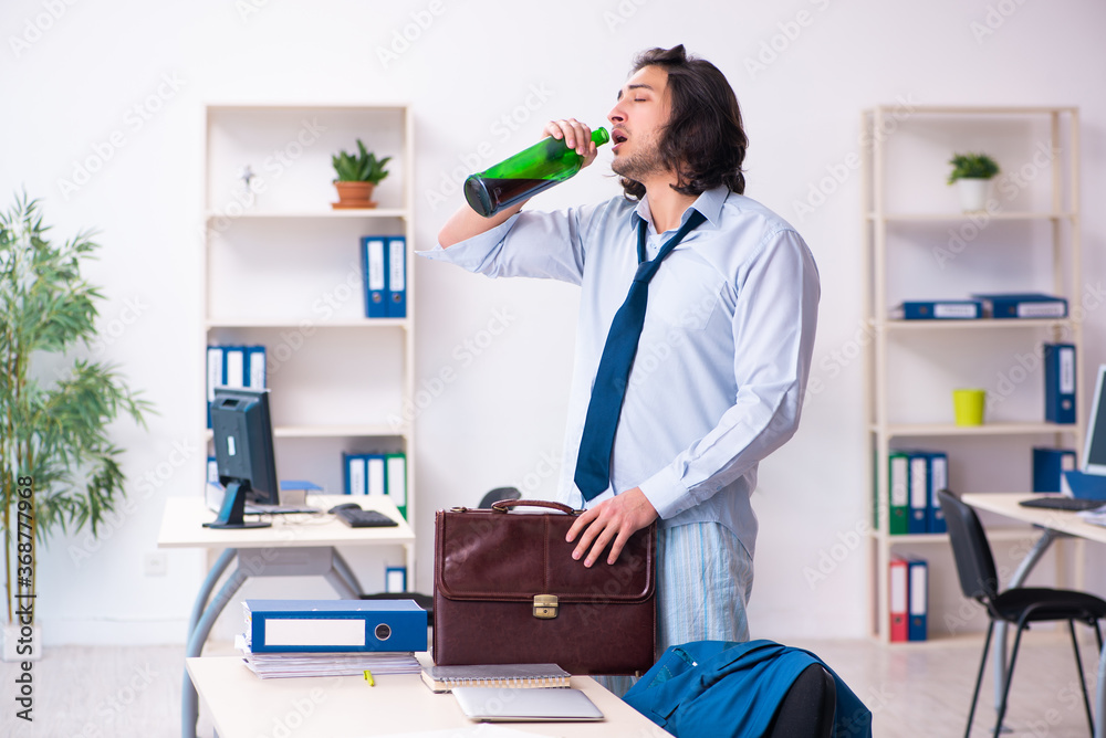 Male employee coming to work after party Male employee coming to work after party
