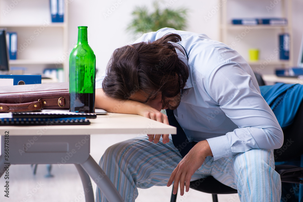 Male employee coming to work after party Male employee coming to work after party