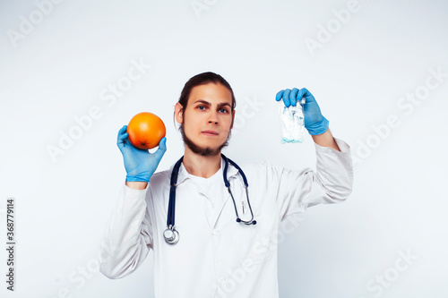 young pretty doctor with stethoscope holding fruits, healthy food care concept