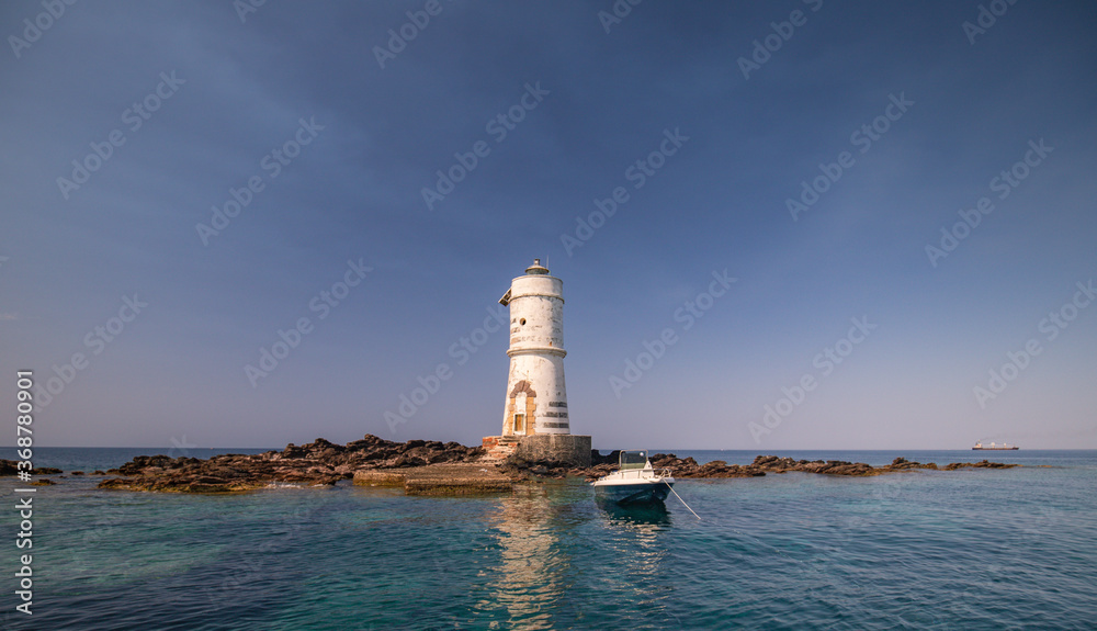 the lighthouse of the boat eater of calasetta, south sardinia, on a beautiful summer day the lighthouse of the boat eater of calasetta, south sardinia, on a beautiful summer day