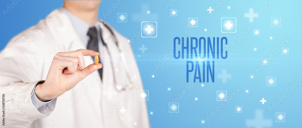 Close-up of a doctor giving a pill with CHRONIC PAIN inscription, medical concept Close-up of a doctor giving a pill with CHRONIC PAIN inscription, medical concept