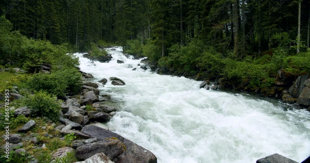 Mountain river during rain weeather near Krimml Waterfalls in High Tauern National Park forest, Austria. Mountain river during rain weeather near Krimml Waterfalls in High Tauern National Park forest, Austria.