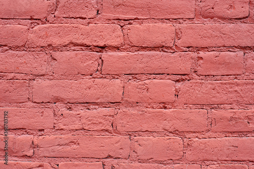 Textured red bricks wall  background with copy space. Old bricks painted in red color  texture of red brick wall facade background close up.
