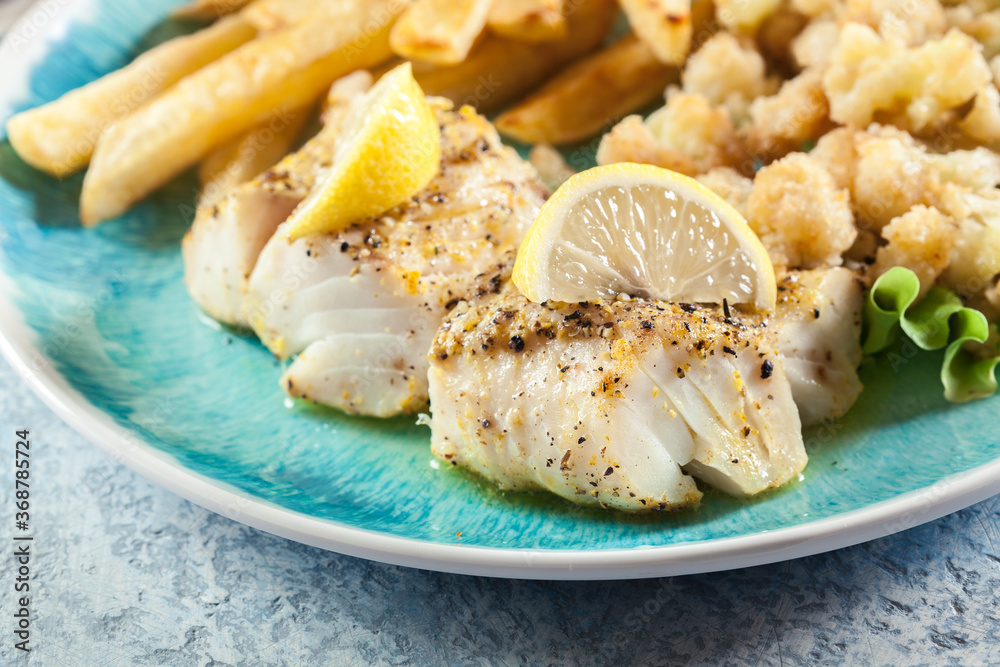 Steamed cod fish with french fries and boiled cauliflower Steamed cod fish with french fries and boiled cauliflower