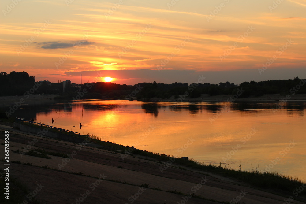 sunset on the river on the embankment evening city landscape postcard