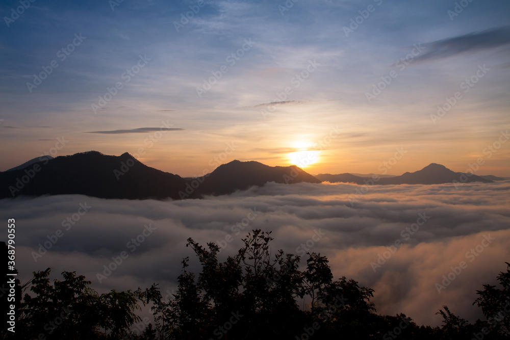 Silhouettes of mountain with light mist in morning sunrise, Beautiful nature lanscape Silhouettes of mountain with light mist in morning sunrise, Beautiful nature lanscape