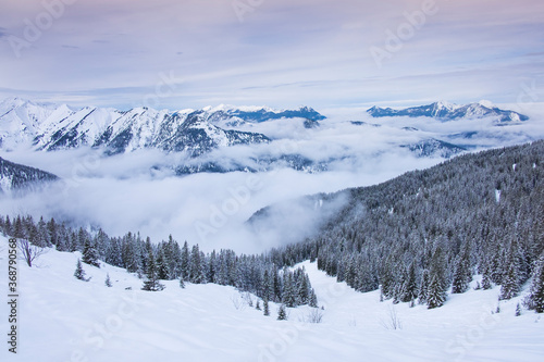 Winter panorama landscape in the Karwendel mountains at Schafreiter, with fog, snow and forest. © Bastian Linder