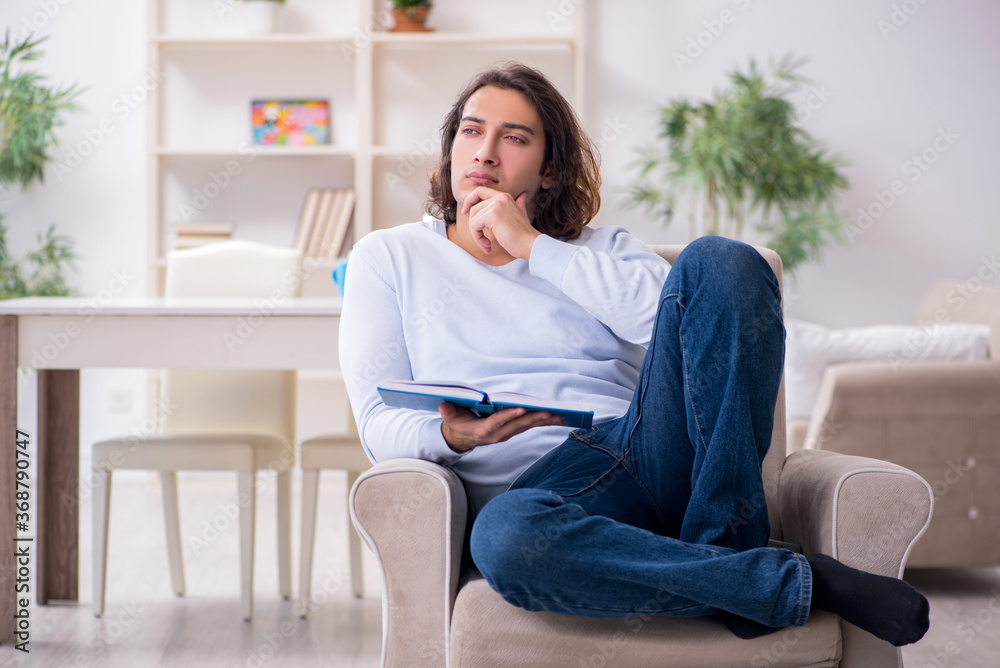 Young male student preparing for exams at home Young male student preparing for exams at home