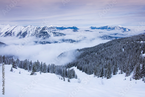 Winter panorama landscape in the Karwendel mountains at Schafreiter  with fog  snow and forest.