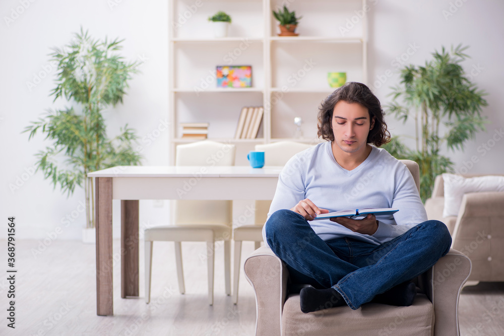 Young male student preparing for exams at home Young male student preparing for exams at home