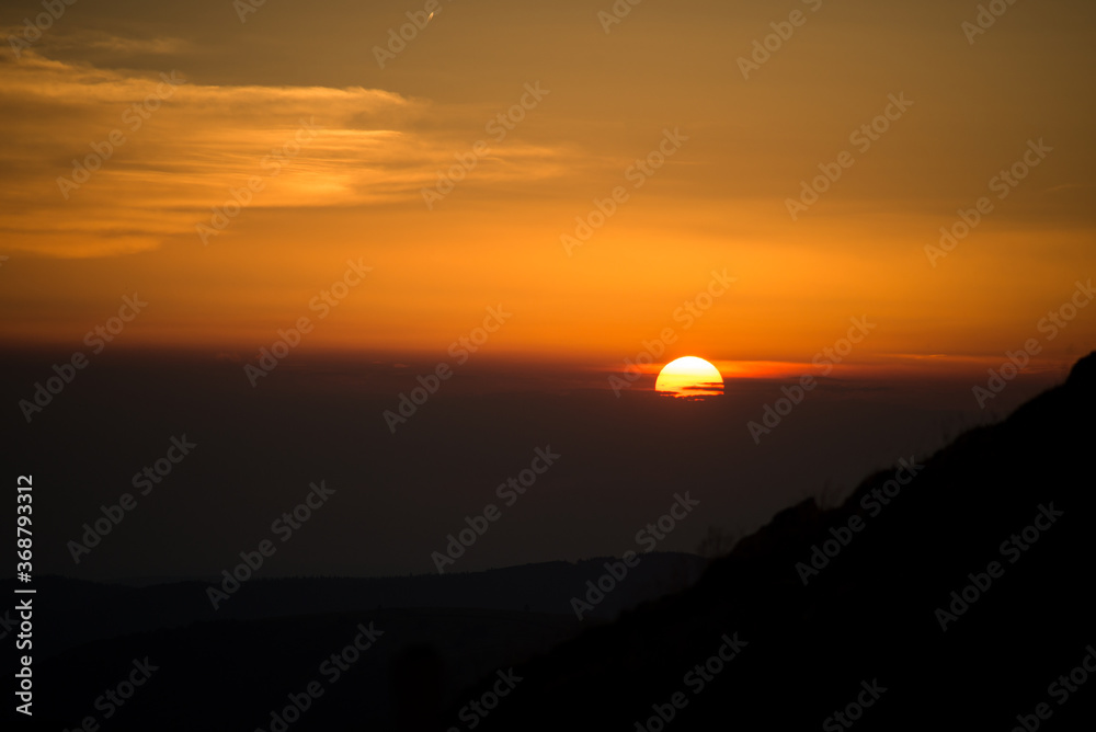 view of sunset on the mountain foreground