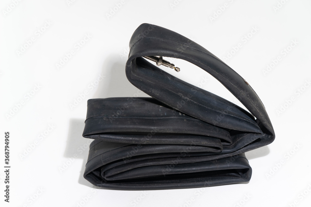 Old deflated Rubber Tire Tube for Bicycling with valve isolated on white background. Old deflated Rubber Tire Tube for Bicycling with valve isolated on white background.
