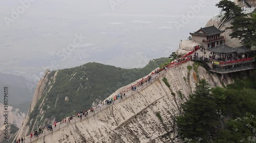 Tourists climbing magnificent Mount Hua or Huashan, a mountain near city of Huayin in Shaanxi, about 120 km east of Xi'an. One of 5 Great Mountains of China with long history of religious significance