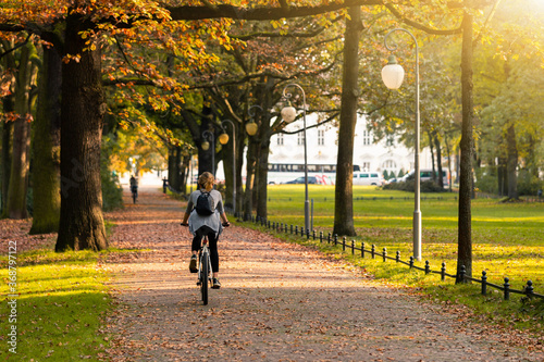 Cyclist rides a bicycle in the Tiergarten park in Berlin	