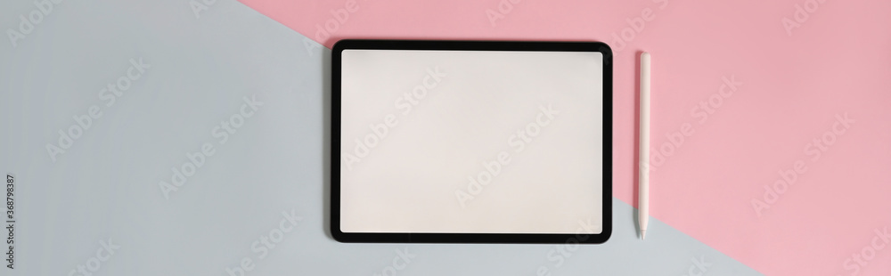 Two tones color workspace is surrounding by white screen tablet and stylus pen.