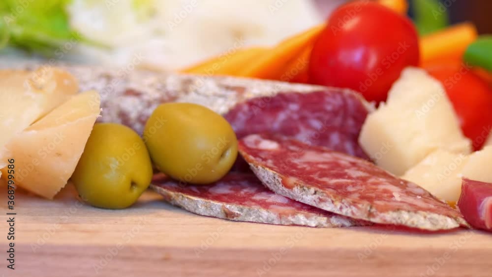 wooden cutting board of salami, cheese and grapes wooden cutting board of salami, cheese and grapes