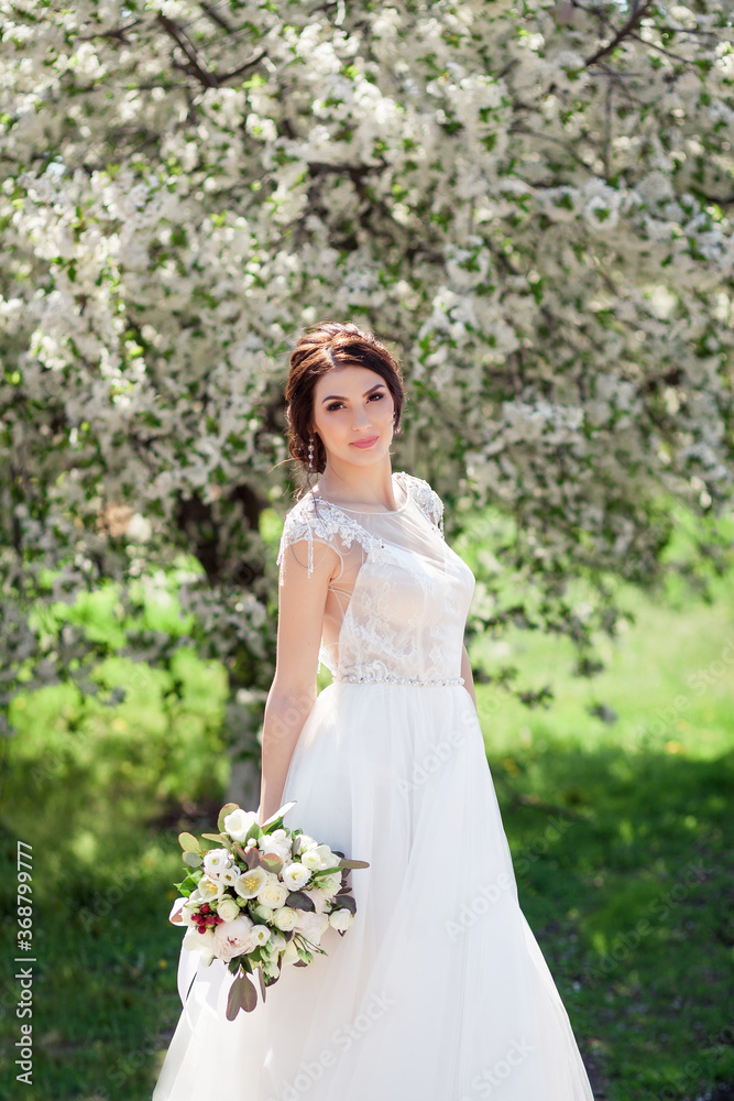 bride in a blooming spring garden