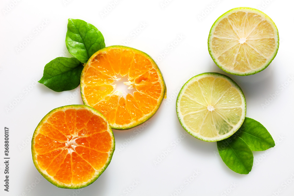lime and orange fruit on white background.